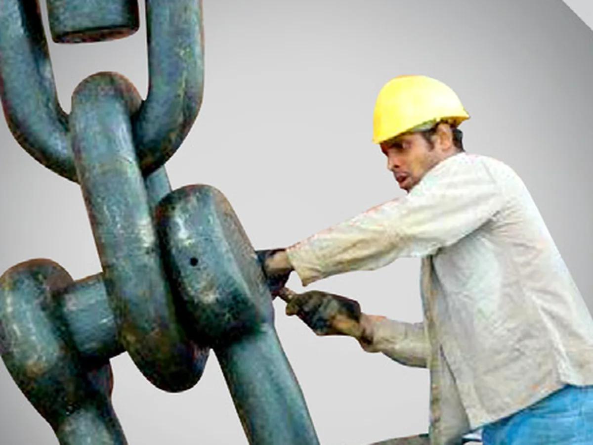 Technician working on a heavy anchor chain
